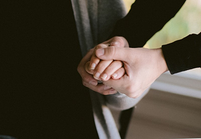 Holding a person's hand to help them